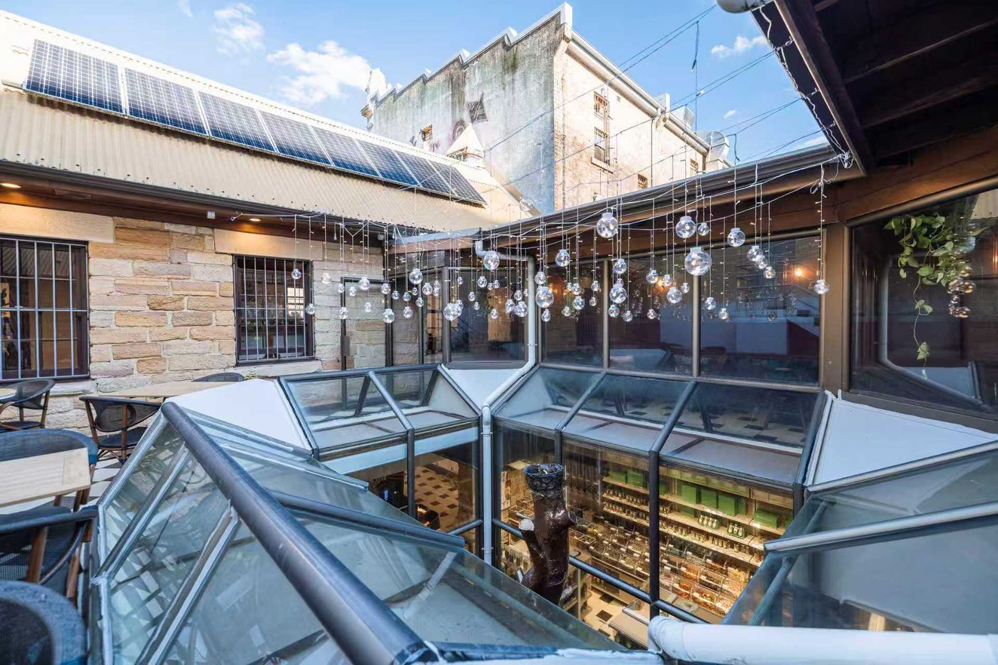 The open-air rooftop courtyard with glass skylights and hanging lights