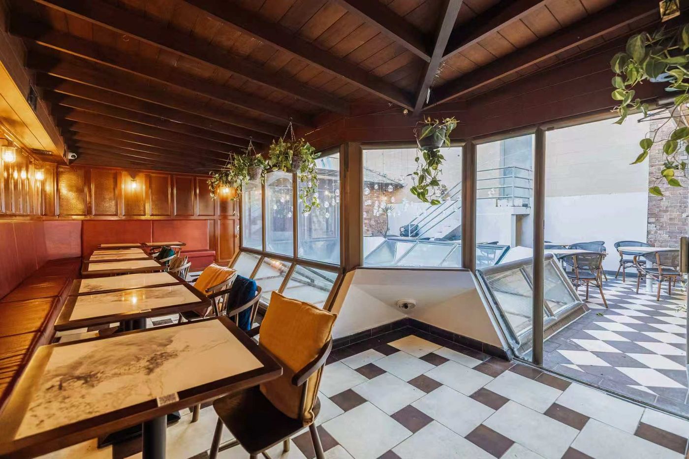The upstairs conservatory with checkerboard floor, banquette and skylight windows