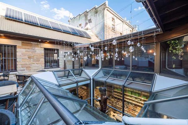The open-air rooftop courtyard with glass skylights and hanging lights